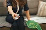 Closeup on football fan woman sitting on couch in loft apartment and watching tv. Modern lifestyle concept.