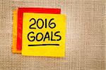 2016 New Year goals - handwriting on a sticky note against burlap canvas