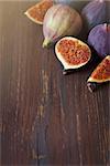 Fresh ripe figs on old wooden board wih place for text.