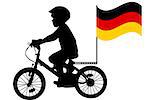 A kid silhouette rides a bicycle with German flag
