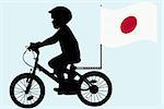 A kid silhouette rides a bicycle with Japan flag