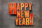 Happy New Year! - text in vintage letterpress wood type blocks stained by red ink on a grunge metal background