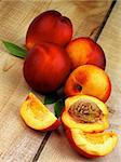 Arrangement of Ripe Peaches Full Body and Slices with Leaf closeup on Wooden background