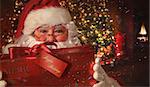 Closeup of Santa Claus holding gift with Christmas scene in background