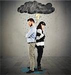Couple under cloud with lightning and rain