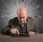 Elderly man touching the tablet with finger