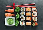 Set of sushi with wasabi and chopsticks on slate