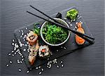 Sushi and seaweed salad on slate table