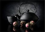 Tea utensil and buds on a black background