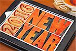 2016 New Year greeting card - word abstract in outlined letterpress wood type blocks stained by red ink on a digital tablet