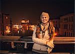 Tune in for charming winter time in Venice, Italy. Happy young woman standing on a bridge overlooking Grand canal