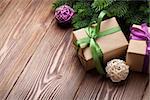 Christmas gift boxes and fir tree on wooden table. Top view with copy space