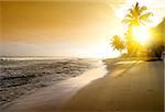 Orange sky over ocean and sandy beach