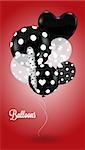 Black and white balls round and heart-shaped with a polka dot pattern on red background