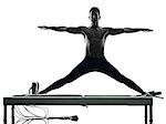 one caucasian man exercising pilates reformer exercises fitness in silhouette isolated on white backgound