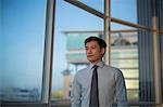 Singapore, Businessman standing at window