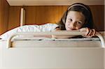 Portrait of young girl lying in bed, Sweden