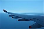 Close-up view of aircraft wing of Airbus A380, during flight over Indonesia at Dusk