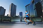 Young Caucasian man running in metropolitan area