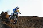 Motocross biker on dirt track