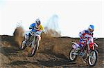 Motocross bikers on dirt track