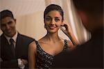 Singapore, Man watching woman putting on earring in front of mirror