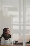 Singapore, Businesswoman sitting at desk in office