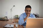 Singapore, Businessman working at laptop in office