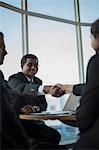 Singapore, Man looking at businessman shaking hands with woman