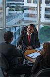 Singapore, Woman looking at two businessmen shaking hands