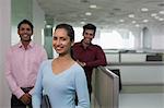 India, Smiling businesswoman in front of colleagues in office