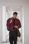 India, Young businessman walking down corridor