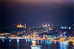 Blue Mosque (Sultan Ahmet Mosque) and Hagia Sophia (Aya Sofya) at night seen from The Galata Tower across the Bosphorus Strait, Istanbul, Turkey, Europe