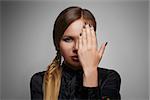 Glamour portrait of beautiful woman  with hand in front of face