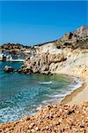 Golden beach and coastline with rocks at the Greek island of Milos