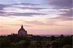 Scenic colorful sunset of ancient temple in Bagan with dramatic clouds, Myanmar