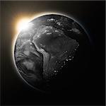 Sun over South America on dark planet Earth isolated on black background. Highly detailed planet surface. Elements of this image furnished by NASA.
