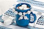 Hot chocolate with marshmallow in blue mug for winter drink