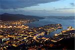 Top view of Bergen (the west coast of Norway) in night. The town is illuminated. Blue sky and sea are in the background.