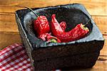dried red hot chili peper on the wooden table horizontal