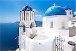 Scenic view of traditional cycladic blue white and blue domes in Oia village, Santorini island, Greece