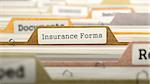 Insurance Forms on Business Folder in Multicolor Card Index. Closeup View. Blurred Image.