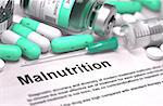 Malnutrition - Printed Diagnosis with Mint Green Pills, Injections and Syringe. Medical Concept with Selective Focus.