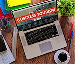 Business Tourism Concept. Modern Laptop and Different Office Supply on Wooden Desktop background.