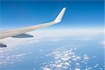 View from th window of a plane of the Wing on sky background