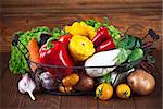 Fresh vegetables in basket on wooden board healthy eating