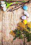 Easter still life with copyspace and spring flowers on wooden board