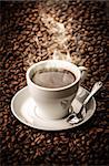 Hot coffee with beans background with spoon