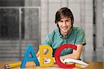 Student sitting in library reading  against abc graphic
