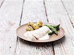 Two haddock fillets with a mornay sauce, served with asparagus and new potatoes